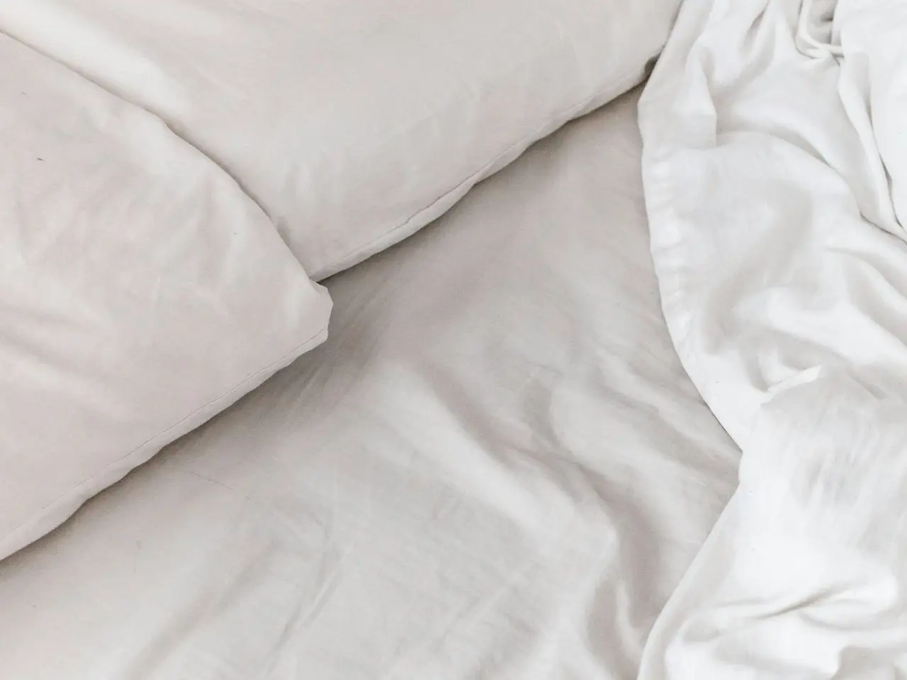 white textile on white bed